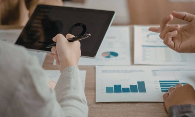 Business owners reviewing marketing analytics and lead tracking data