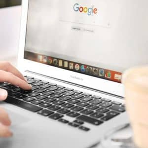 A laptop showing Google search results, highlighting how Google prioritizes trusted businesses for searchers