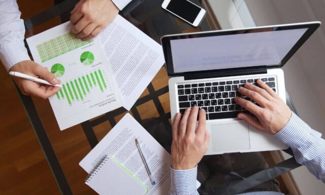 Professionals reviewing site plans together while discussing project details and business decisions